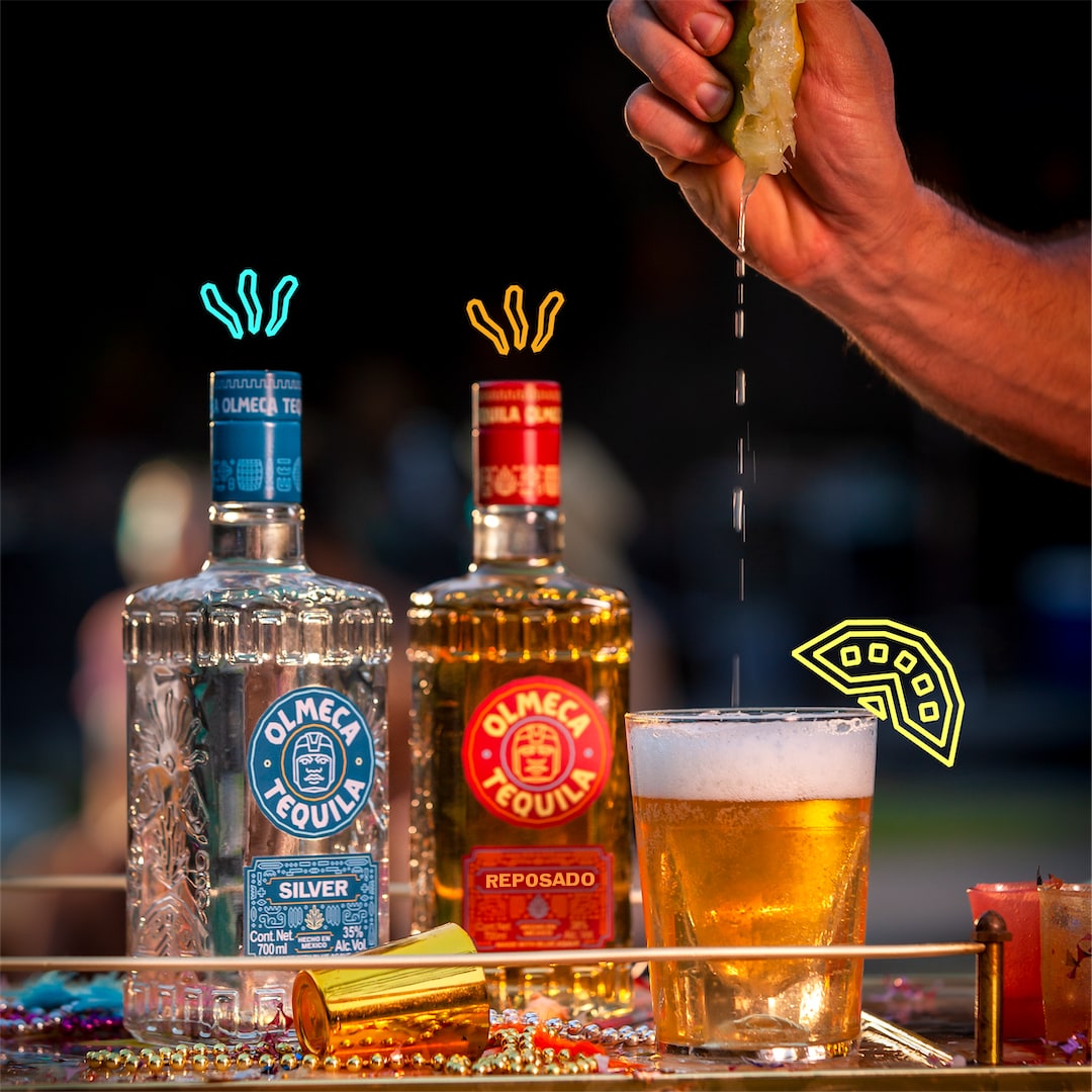Two bottles of Olmeca and a glass that gets lime squeezed into it