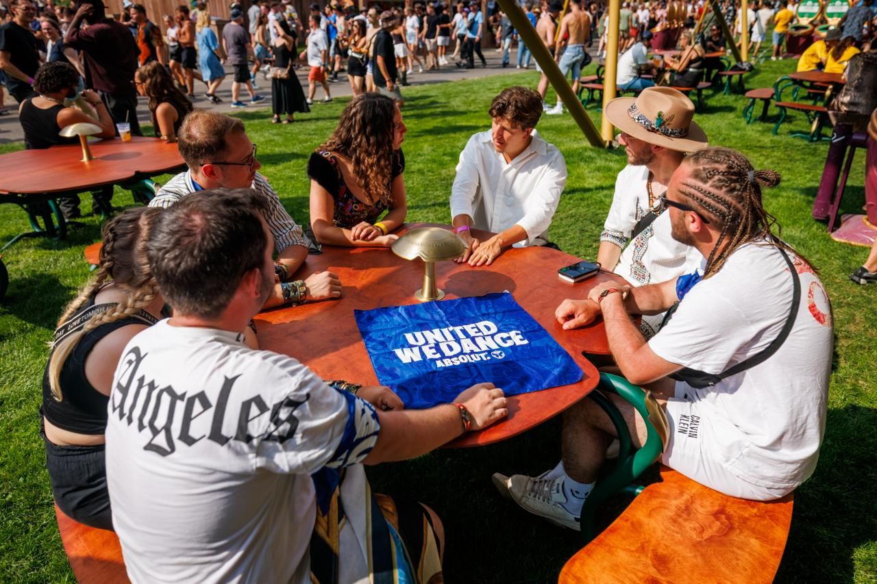 A group of people at Tomorrowland sitting around a table