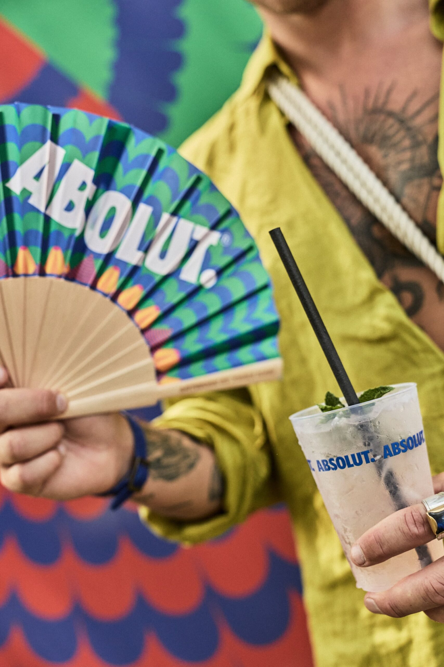 Person holding Absolut fan and drink